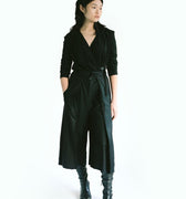 Front view of a woman wearing Werable's easy-grip buckle wrap shirt with hakama culottes in black.