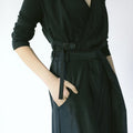 Close-up of Werable’s easy-grip buckle wrap shirt with black hakama culottes, emphasizing the front pleats of the pants.