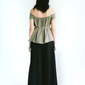Back view of a woman wearing Werable's sage green off shoulder top with Hakama full length pants in black.