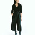 Front view of a woman wearing Werable's easy-grip buckle wrap shirt with hakama culottes in black. 