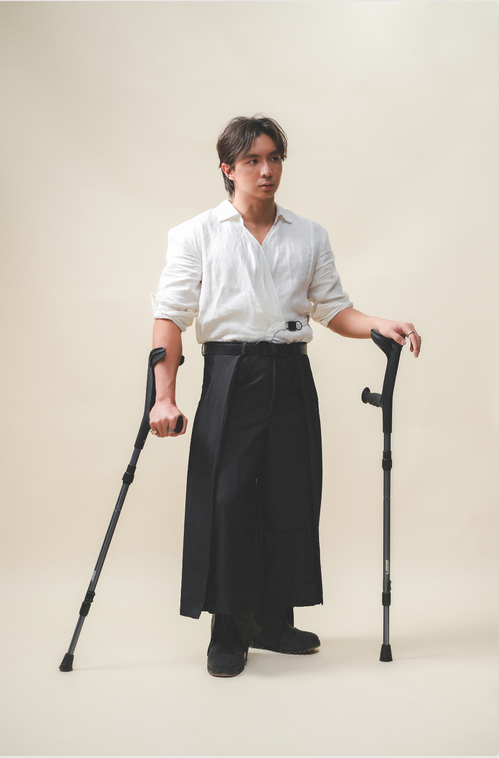 A man standing, wearing Werable's easy grip buckle shirt in white and black Hakama Culottes.