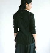 Back view of a woman wearing Werable's easy grip buckle wrap shirt with hakama culottes in black. 