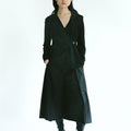 Front view of a woman wearing Werable's easy grip buckle wrap shirt with hakama culottes in black. 