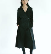 Front view of a woman wearing Werable's easy grip buckle wrap shirt with hakama culottes in black. 